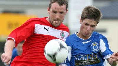 Cliftonville's Marc Smyth challenges Stefan Lavery of Dungannon Swifts for the ball