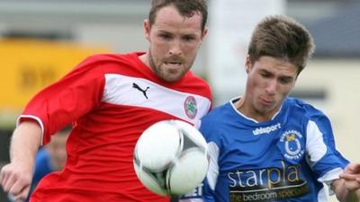 Cliftonville's Marc Smyth challenges Stefan Lavery of Dungannon Swifts for the ball