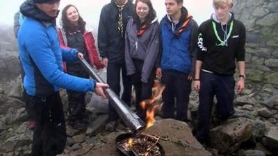 Scouts gather as the Paralympic torch is lit at the summit of Ben Nevis