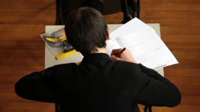 A pupil sitting a maths exam