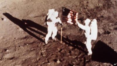Neil Armstrong and Edwin Aldrin, plant the US flag on the lunar surface July 20 1969