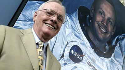 US astronaut Neil Armstrong poses in front of his photograph