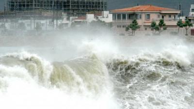 High waves pound the shore in Yonabarucho, Okinawa Prefecture, Japan