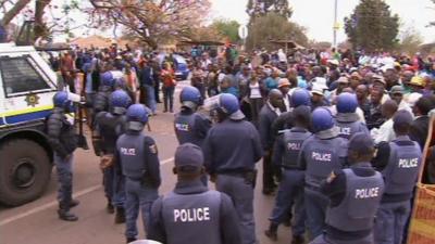 Police officers and protesters gathered near the Marikana mine