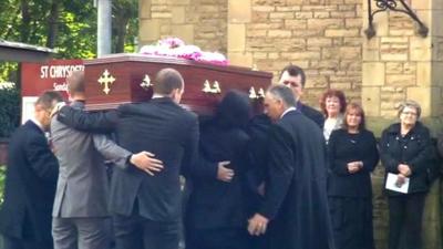 Coffin carried into church