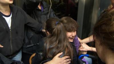 Lady in a wheelchair amid scuffles.