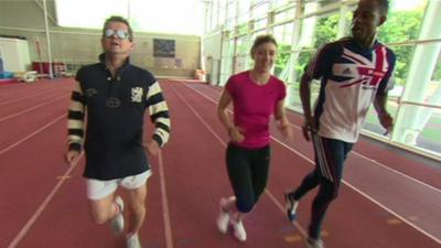 Libby Clegg leads a blindfolded Mike Bushell through his paces