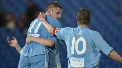 Ballymena United players celebrate taking the lead against Lisburn Distillery