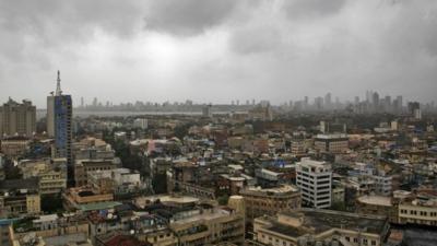 Monsoon clouds loom over Mumbai"s skyline. Are dark clouds looming over the economy?