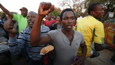 Miners and their supporters dance after being released outside the court