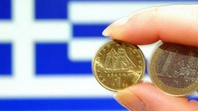 Euro and drachma coins plus Greek flag