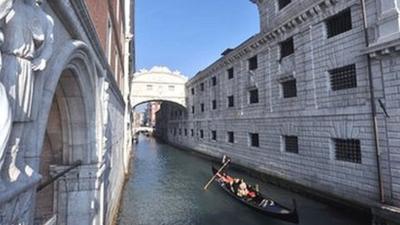 A gondola passes Venice's Bridge of Sighs