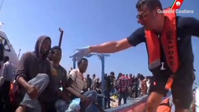 migrants are rescued by Italian Coast Guard officials