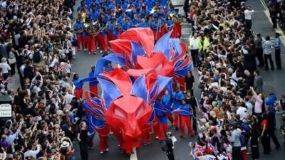 Performers dressed as red and blue lions pass along Fleet Street during the London 2012 Victory Parade for Team GB and Paralympic GB athletes