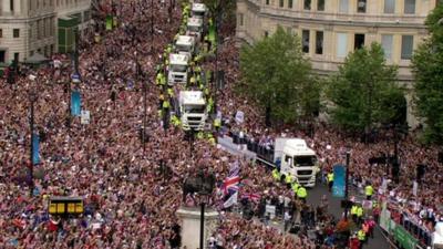 Crowds gather to cheer on British Olympic and Paralymic athletes on through their parade of London