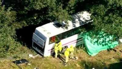 Crashed coach being inspected by police