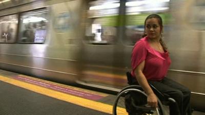 Wheelchair user Viviane Macedo waiting for a train in Rio