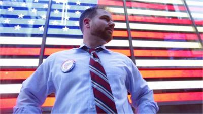 Comedian in front of US flag