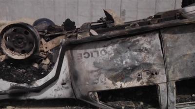 Burnt out police car