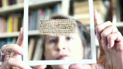 Harvard divinity professor Karen King holds the ancient scrap of papyrus