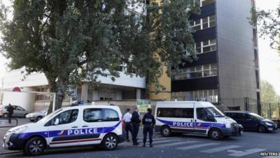 French police cars are parked in front of satirical weekly Charlie Hebdo offices in Paris