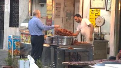 Man buying food at market stall