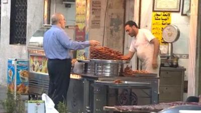 Man buying food at market stall