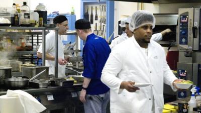 Prisoners working in The Clink Kitchen at High Down Prison