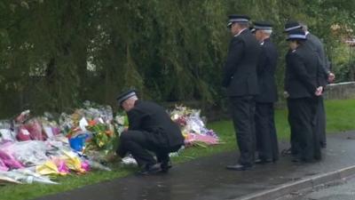 Police laying flowers