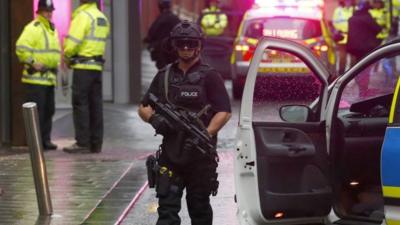 An armed police officer standing guard