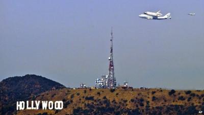 Space shuttle Endeavour flies over Hollywood sign