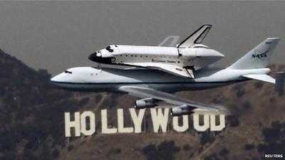 Space shuttle Endeavour flies over Hollywood sign