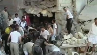 Syrians looking through rubble in Aleppo