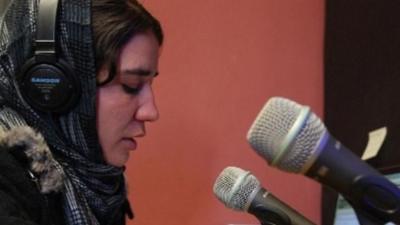 An Afghan women in a radio station.