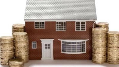 detached model house with pound coins