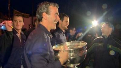 Jim McGuinness and Michael Murphy walk the Sam Maguire Cup across the border into county Donegal at Pettigo