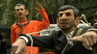 People dressed as Syria's President Assad and Iran's President Ahmedinijad outside the UN