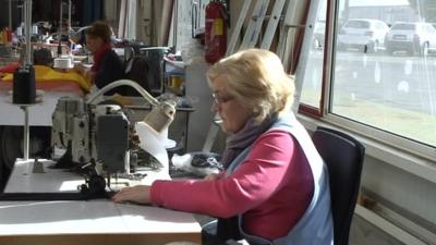 A women working at a sewing machine