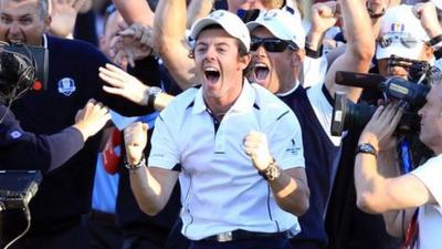 Rory McIlroy celebrates after Martin Kaymer's putt on the 18th