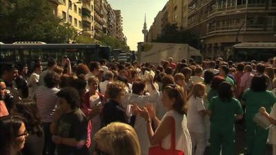 Public hospital workers in Spain protest by blocking a busy road in Madrid