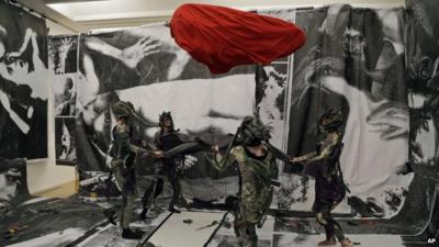 Performers take part at Turner Prize nominee Spartacus Chetwynd's performance entitled "Odd Man Out 2011" at Tate Britain in London