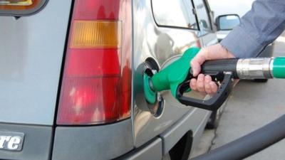 Man fills up his car tank