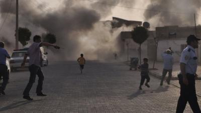 Smoke rises over the streets after a shell landed from Syria in the Turkish border village of Akcakale, south-eastern Sanliurfa province, 3 October 2012