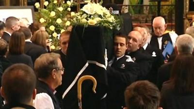 Police officers carrying Hughes' coffin into Cathedral