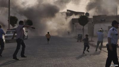 Smoke rises over the streets after a shell landed from Syria in the Turkish border village of Akcakale, south-eastern Sanliurfa province, 3 October 2012