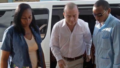 Cuban security forces escort Spanish citizen Angel Carromero, centre, to the courthouse to attend his trial in Bayamo