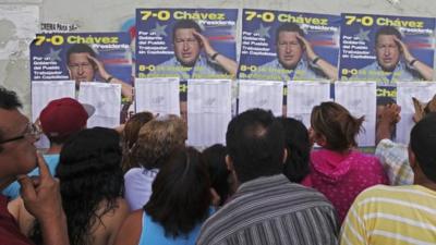 Voters and Chavez posters