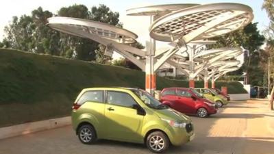 Electric cars being charged by solar power, India