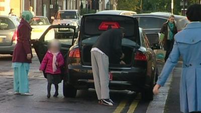 Family getting out of car parked on double yellow lines