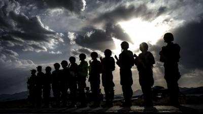 Afghan policemen stand guard for a debriefing during an exercise under the supervision of the Eurogendfor, on September 26, 2012, in the National Police Training Center (NPTC) in the Wardak province